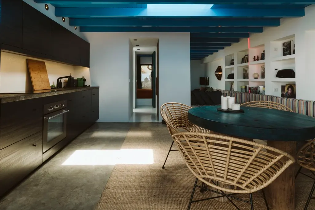 Hallway with teal ceiling beams and white walls